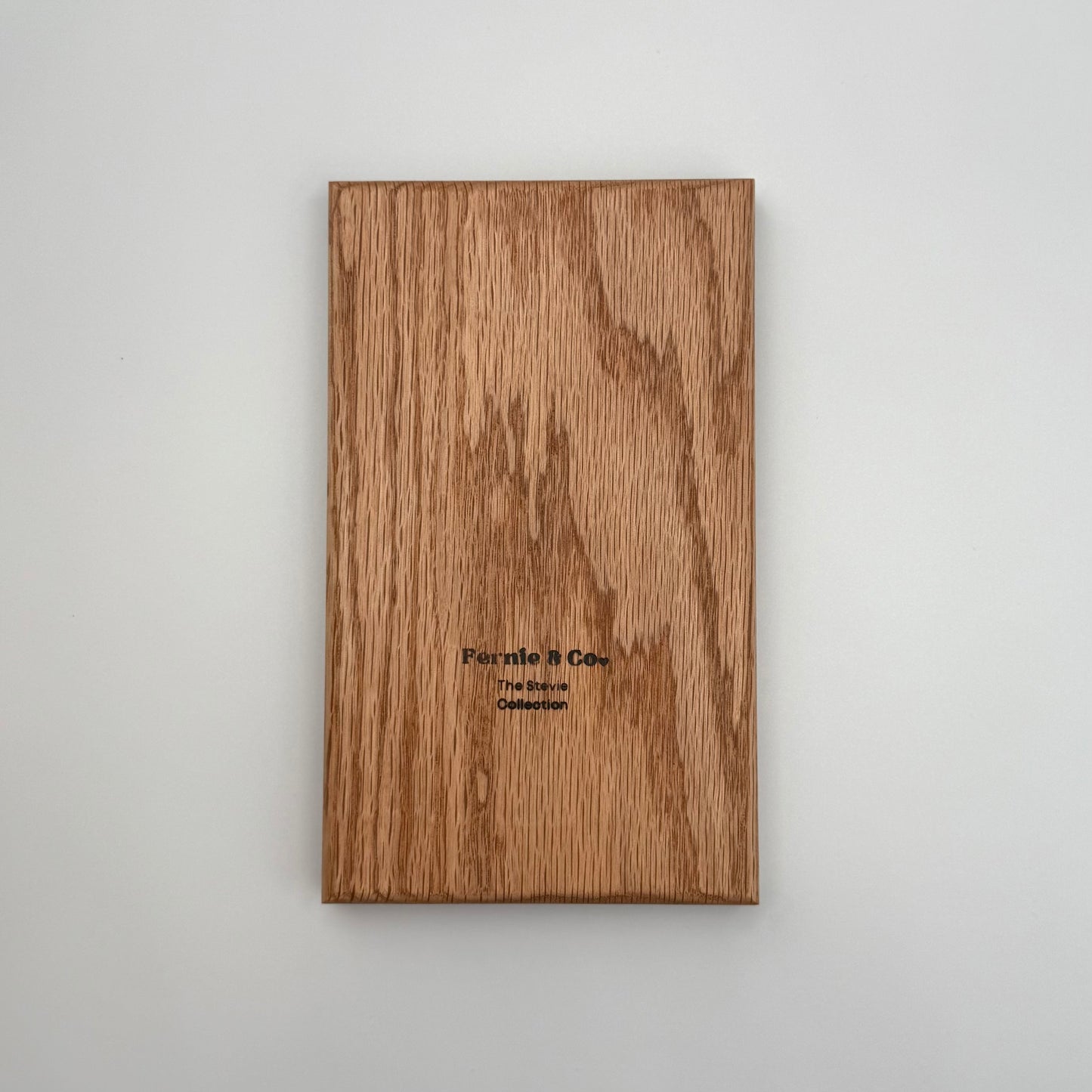 the back of the red oak tic tac toe board including a Fernie and Co. logo.