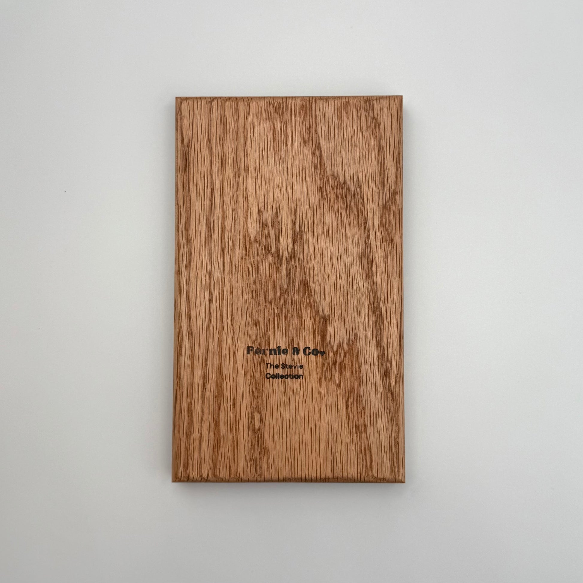the back of the red oak tic tac toe board including a Fernie and Co. logo.