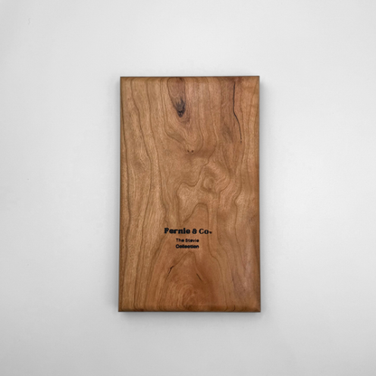 The back of a solid cherry wood tic tac toe game board with a Fernie and Co. logo.