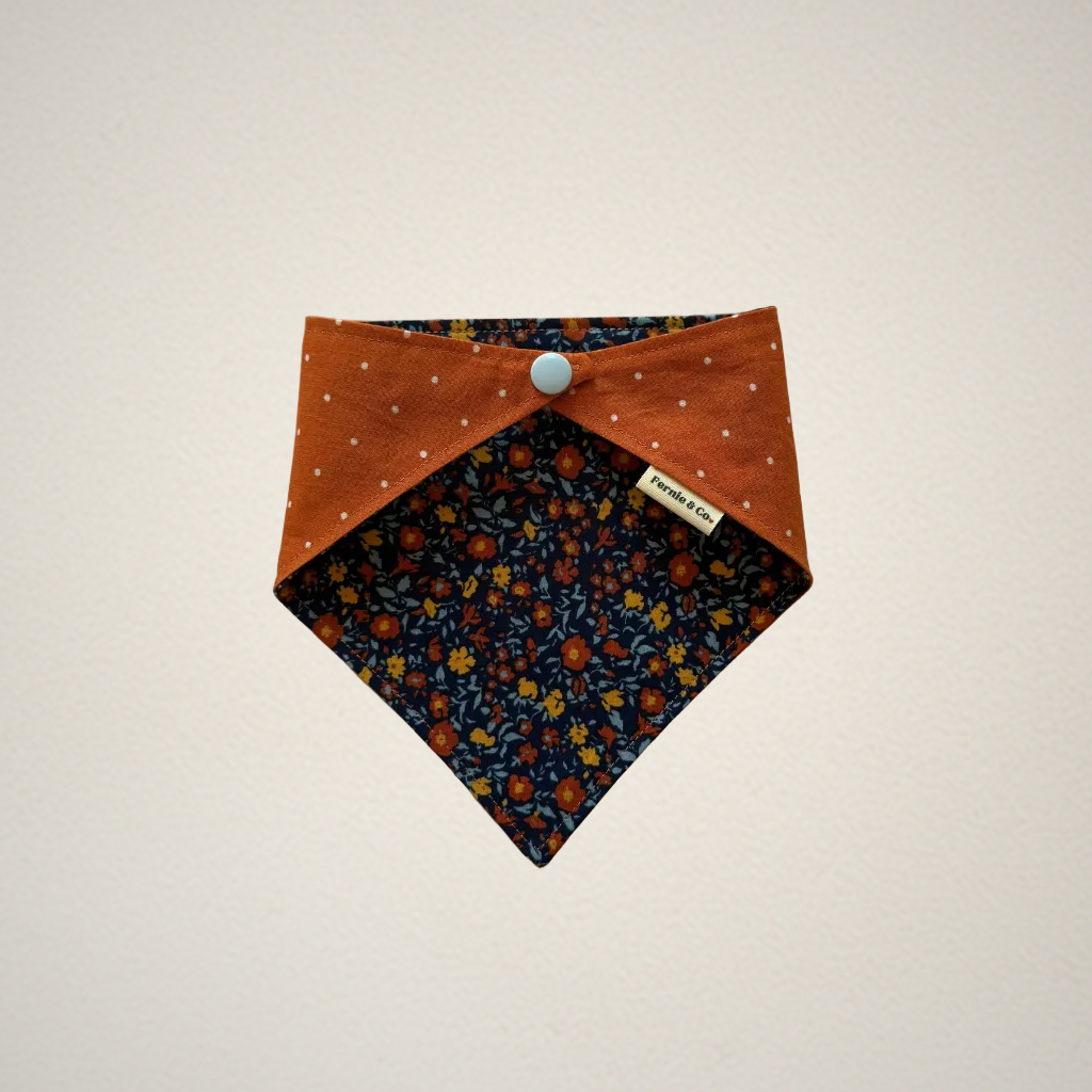 pet bandana with multicolor floral fabric and orange fabric with white dots